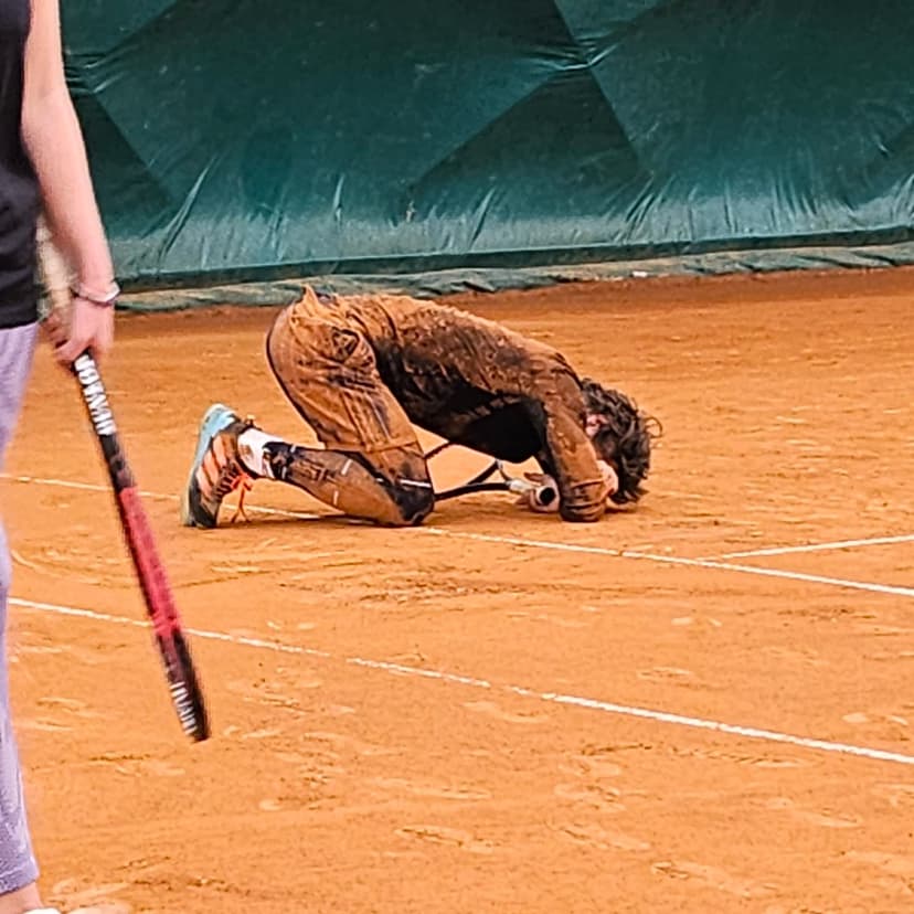 Tennis coach instructing a player